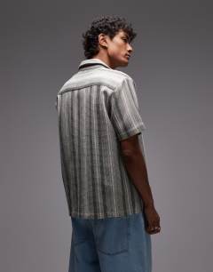 Model wearing Short sleeve revere stripe shirt in green and white