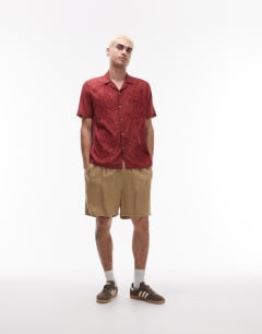 Model wearing Short sleeve sheer embroidered floral shirt in red