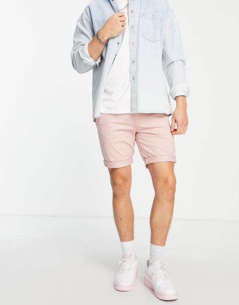 ASOS DESIGN shorter length denim shorts in mid wash with heavy rips