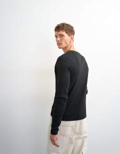 Model wearing Slim fit long sleeve rib henley t-shirt in black