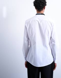 Model wearing Slim fit long sleeve tuxedo shirt with bib in white