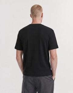 Model wearing Slim fit rib henley t-shirt in black