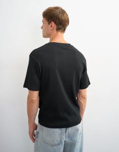 Model wearing Slim fit rib henley t-shirt in black