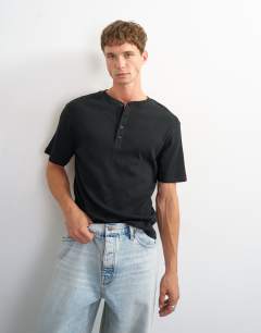 Model wearing Slim fit rib henley t-shirt in black