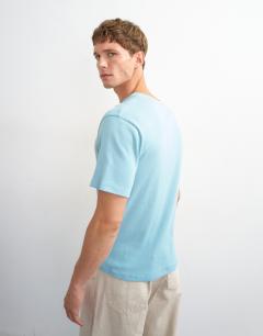 Model wearing Slim fit rib henley t-shirt in light blue