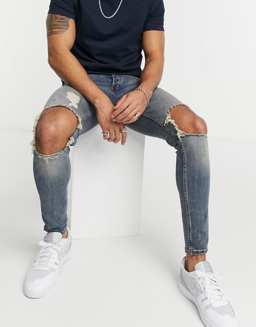 Topman organic cotton spray on jeans with blow out rip in vintage mid wash