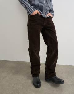 Model wearing Straight fit jeans with coated velour finish in brown