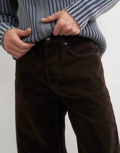 Model wearing Straight fit jeans with coated velour finish in brown