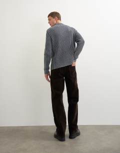 Model wearing Straight fit jeans with coated velour finish in brown