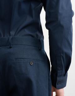 Model wearing Straight fit linen blend trousers in navy