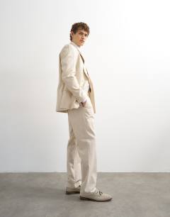 Model wearing Straight fit linen blend trousers in stone
