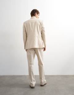 Model wearing Straight fit linen rich trousers in stone