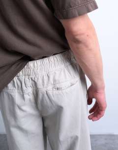 Model wearing Straight leg twill elasticated waist trouser in stone