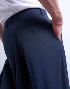 Model wearing Straight wool touch suit trousers in navy