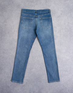 Model wearing Stretch slim jean in mid wash