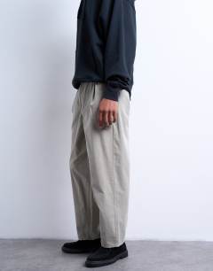 Model wearing Taper fit canvas trouser in stone