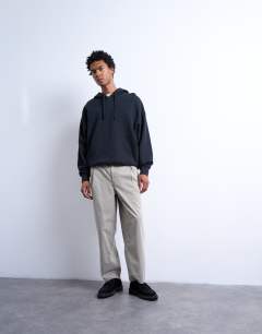 Model wearing Taper fit canvas trouser in stone