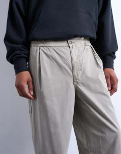 Model wearing Taper fit canvas trouser in stone