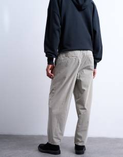 Model wearing Taper fit canvas trouser in stone