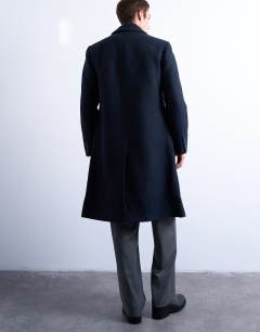 Model wearing Textured double breasted wool blend coat in navy  