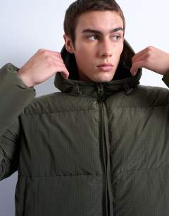 Model wearing Textured puffer jacket in dark khaki