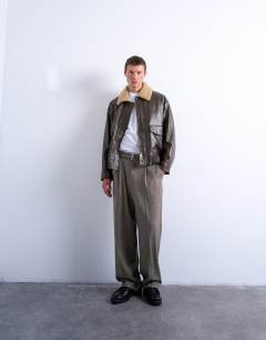 Model wearing Wide leg belted houndstooth trousers in brown