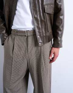 Model wearing Wide leg belted houndstooth trousers in brown
