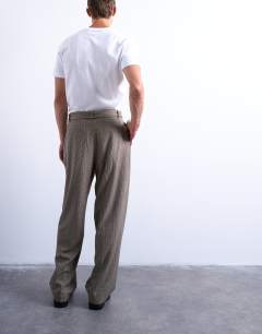 Model wearing Wide leg belted houndstooth trousers in brown