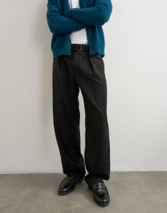 Model wearing Wide leg belted pinstripe trouser with pleats in black