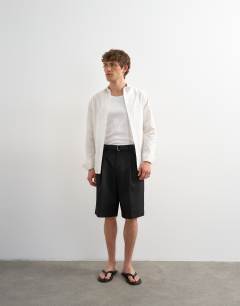 Model wearing Wide leg belted twill short in black