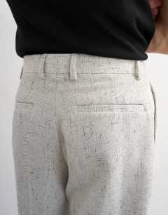 Model wearing Wide leg boucle textured trousers in cream