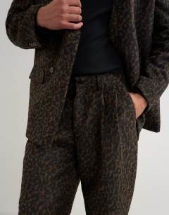 Model wearing Wide leg leopard print trouser in brown