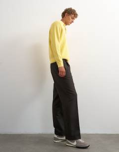Model wearing Wide leg micro check trouser with pleats in brown