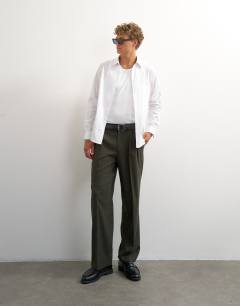 Model wearing Wide leg pinstripe trousers in dark green