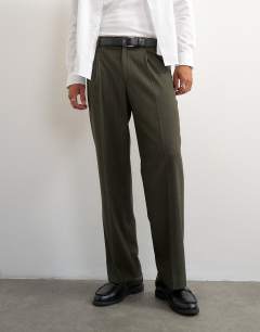 Model wearing Wide leg pinstripe trousers in dark green