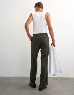 Model wearing Wide leg pinstripe trousers in dark green