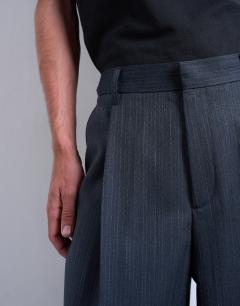 Model wearing Wide leg pleated stripe trouser in grey