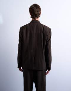 Model wearing Wide leg pleated trouser in brown stripe
