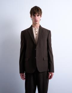 Model wearing Wide leg pleated trouser in brown stripe