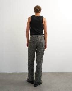 Model wearing Wide leg textured herringbone trouser in black