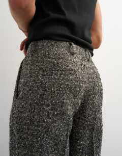 Model wearing Wide leg textured herringbone trouser in black