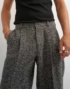 Model wearing Wide leg textured herringbone trouser in black