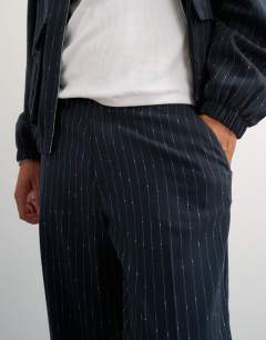 Model wearing Wide leg trouser with boucle pinstripe in navy
