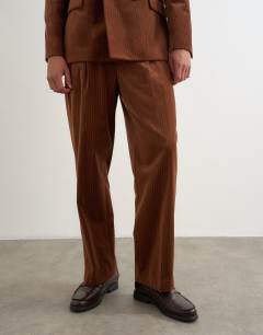 Model wearing Wide leg velour stripe trousers with pleats in tan