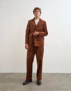 Model wearing Wide leg velour stripe trousers with pleats in tan