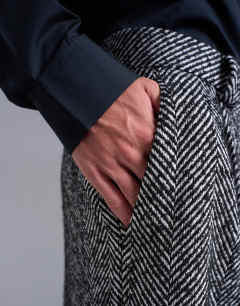 Model wearing Wide leg wool blend herringbone trousers in black