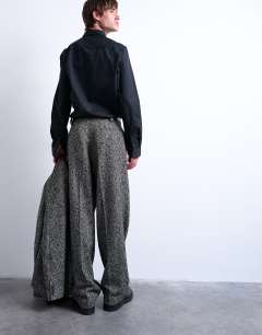 Model wearing Wide leg wool blend herringbone trousers in black