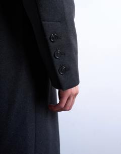 Model wearing Wool blend waisted double breasted overcoat in charcoal
