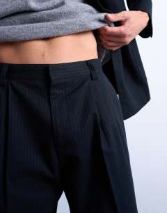 Model wearing Wool blend wide leg striped suit trouser in navy