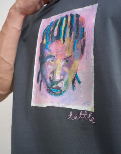 Model wearing Topman x Akilah relaxed fit abstract portrait graphic t-shirt with embroidery in charcoal